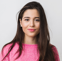 Girl with long hair wearing a
            pink sweater